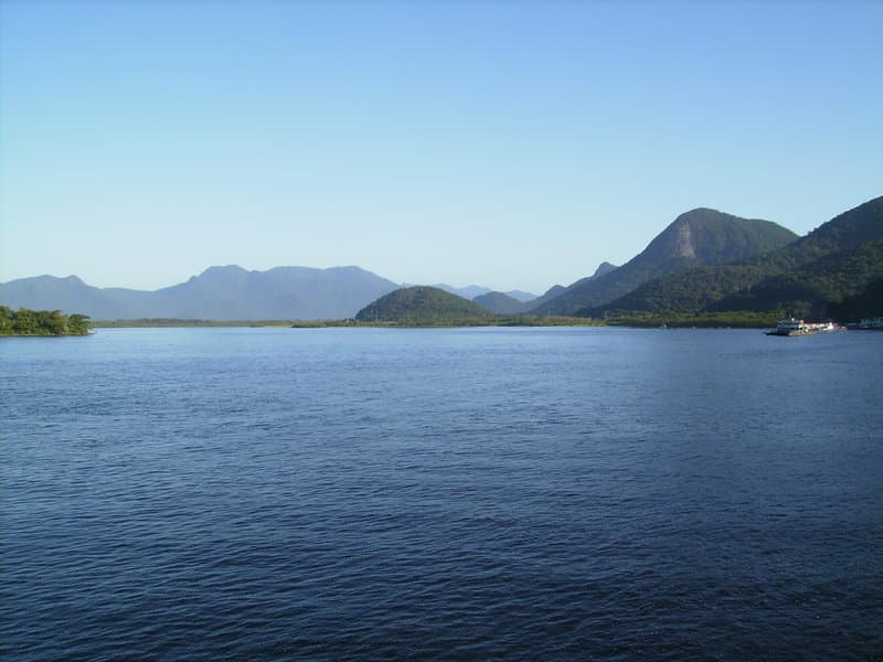 Extensa lâmina d'água da Baía de Guaratuba sob montanhas da Serra do Mar
